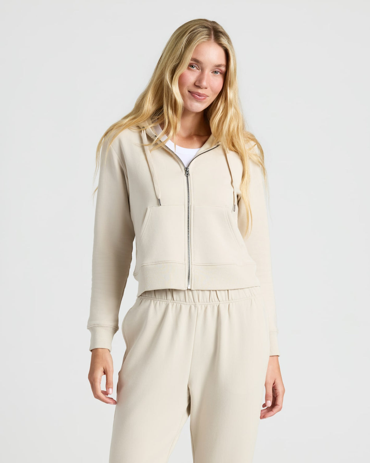 Womens Oatmeal Crop Zip Hoodie & Relaxed Jogger shown on model.