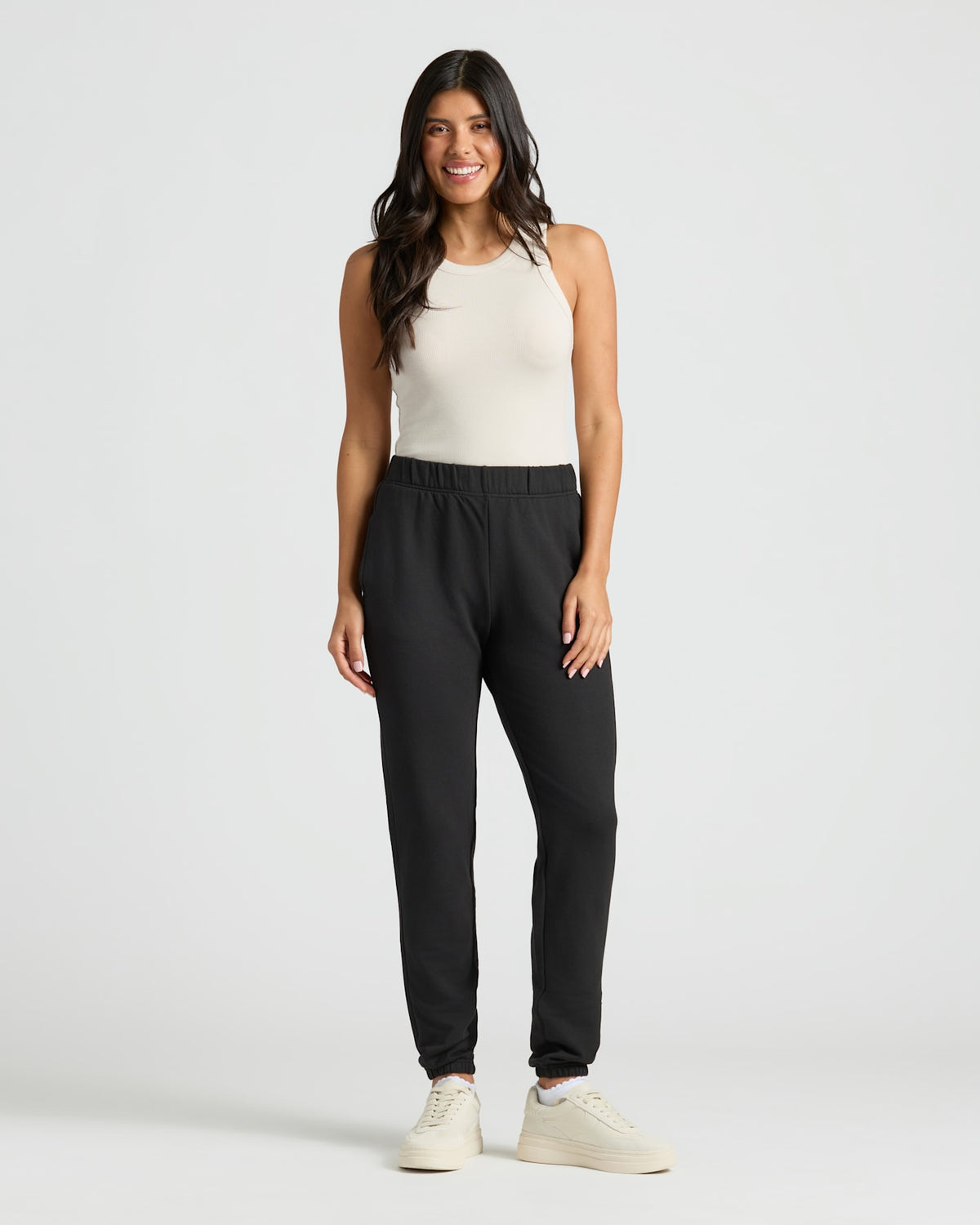 Woman in Womens Black Relaxed Joggers, smiling confidently.