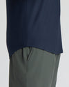 Navy blue long-sleeve shirt and gray pants on a white background