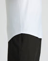 Close-up of a man wearing the All White Active Curved Hem Crew 6-Pack shirt, showing the curved hem detail over black athletic pants as a men's basics essential.