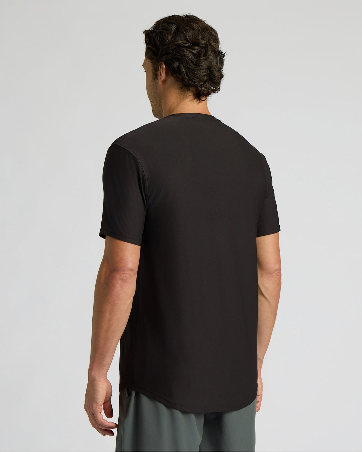 Man wearing a black t-shirt on a light gray background
