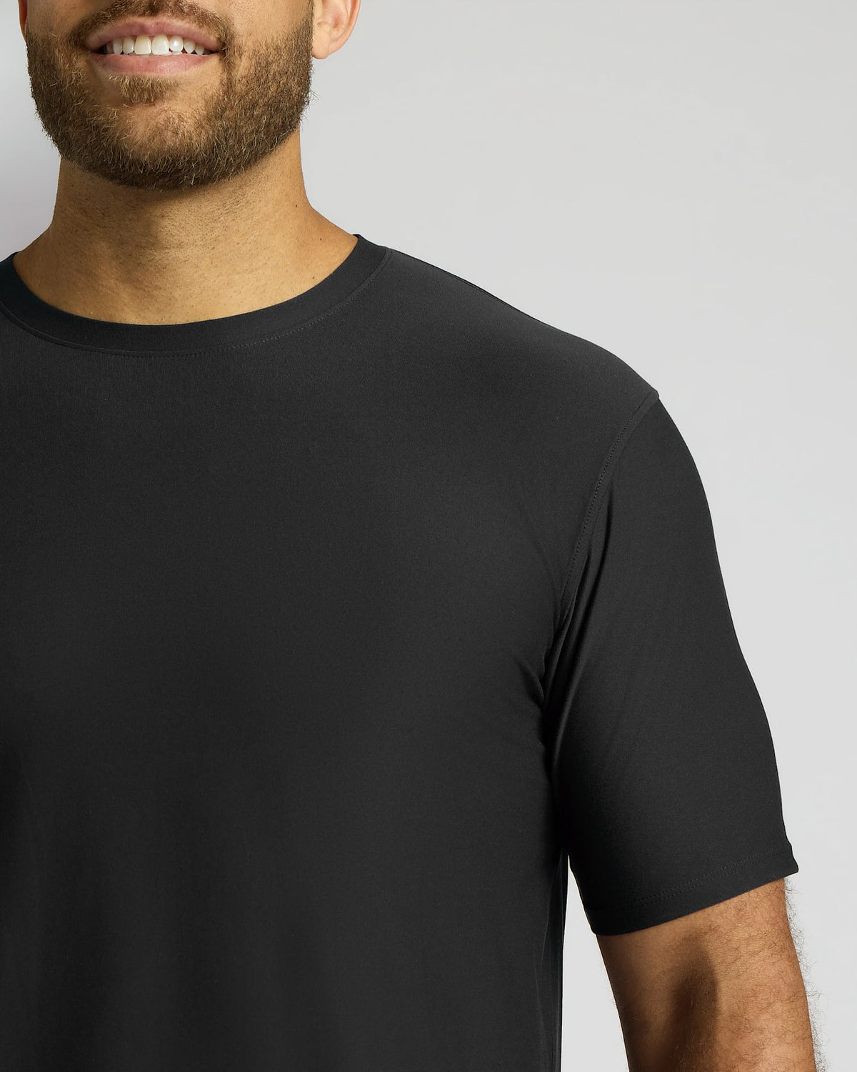 Man wearing a black t-shirt against a plain background