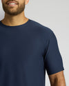 Man wearing a navy blue t-shirt against a plain background