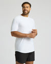 Man wearing a white t-shirt and black shorts on a plain background