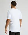 Man wearing a white t-shirt on a plain background