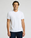 Man wearing a plain white t-shirt against a light gray background