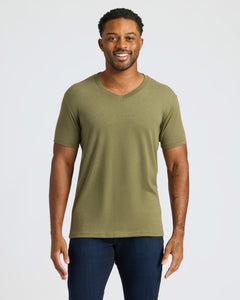 True ClassicMan wearing Classic V-Neck T-shirt and jeans, smiling.