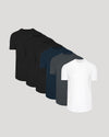 Six short-sleeve crew-neck t-shirts arranged in a diagonal stack on a light gray background, showing color options from black to white.