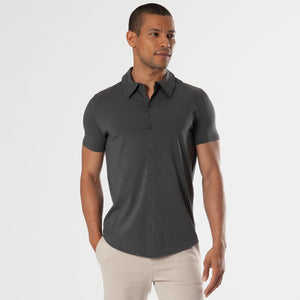 True ClassicMale model wearing Carbon Short Sleeve Knit Shirt and light-beige trousers.