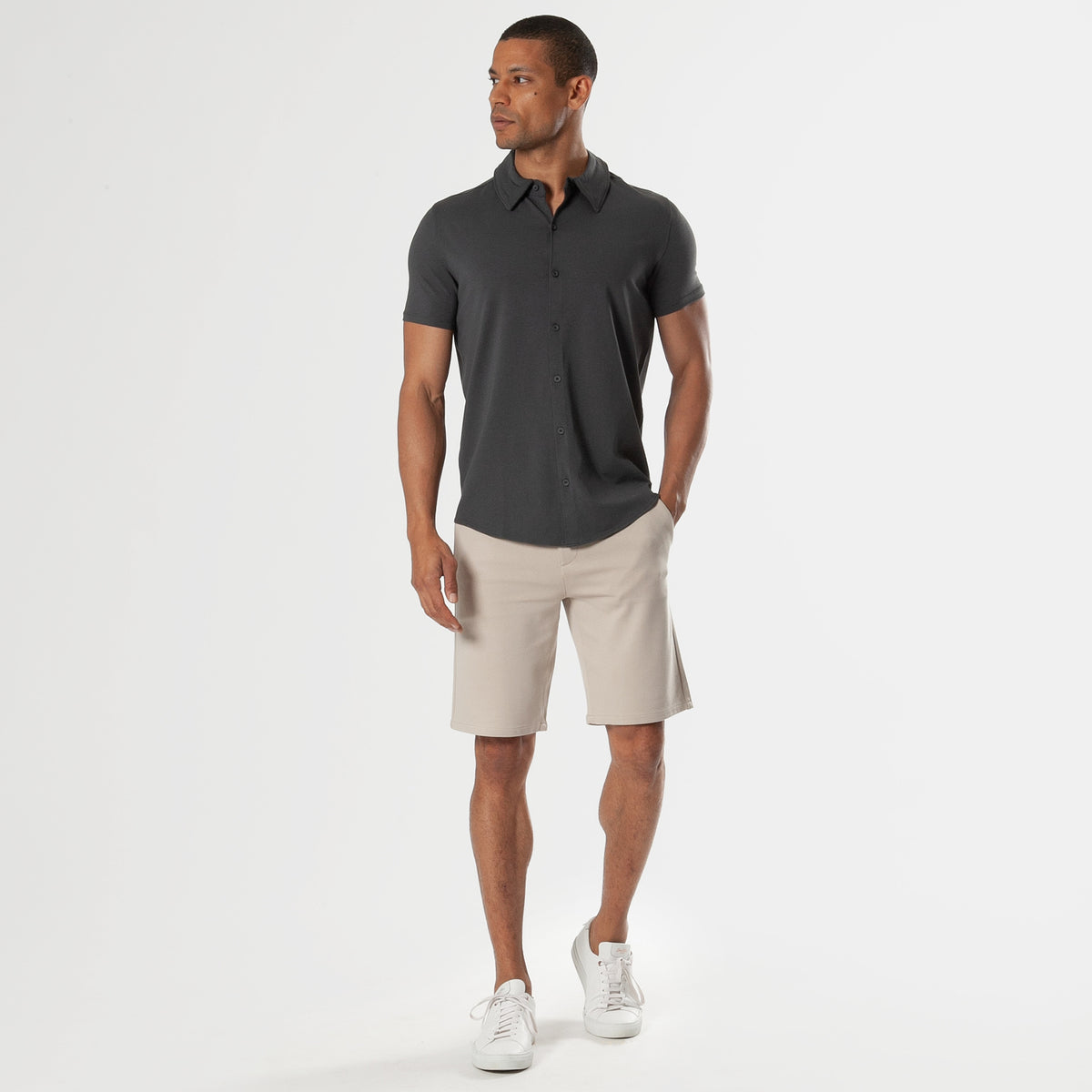 Carbon Short Sleeve Knit Shirt modeled with beige shorts and white sneakers.
