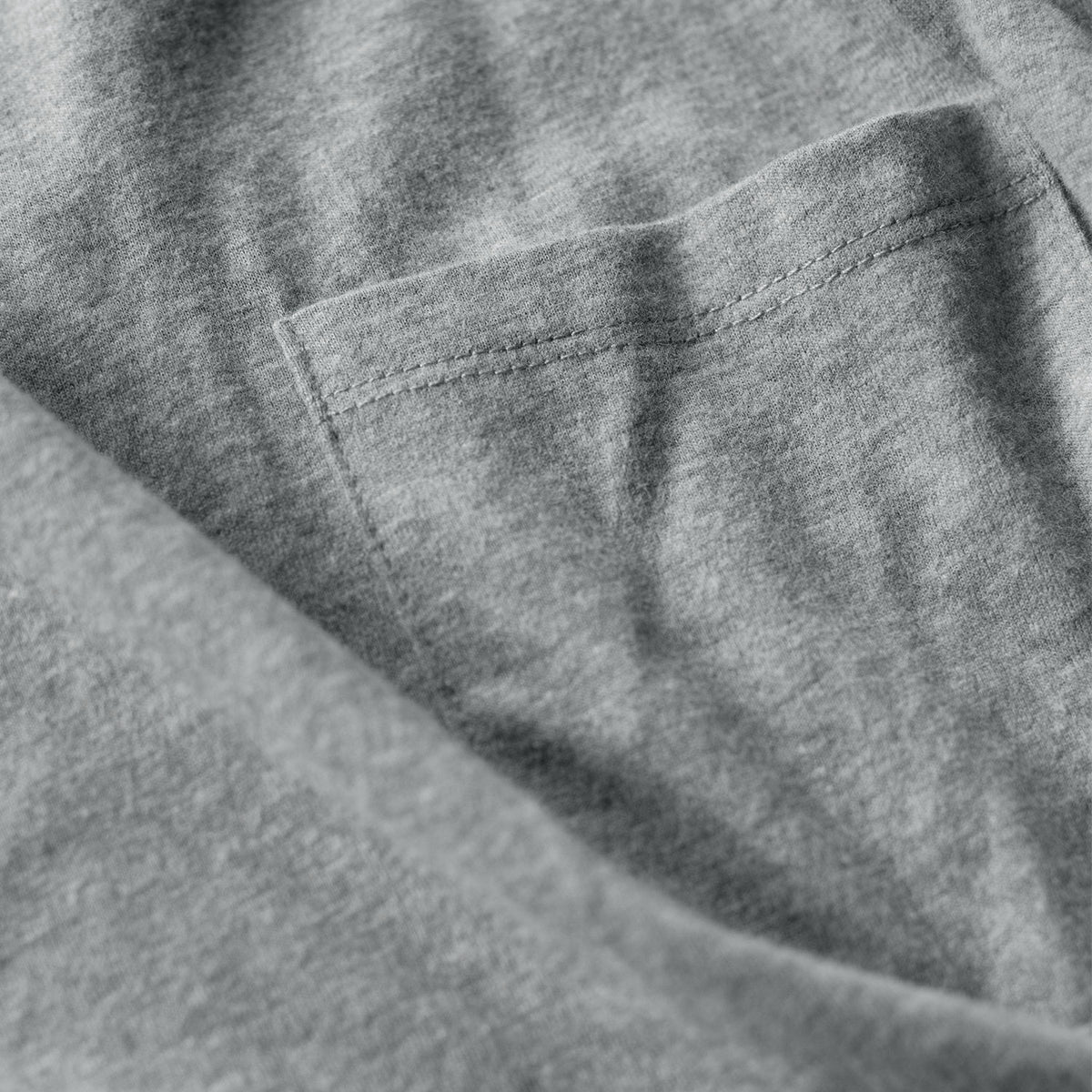 Heather gray crew neck t-shirt with chest pocket and soft fabric texture.